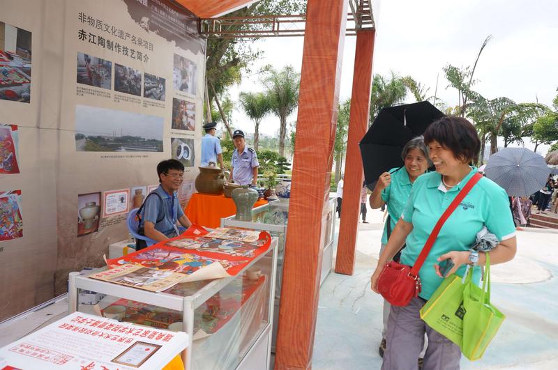 图为游客在参观门神绘画技艺和赤江陶。苏远志拍摄